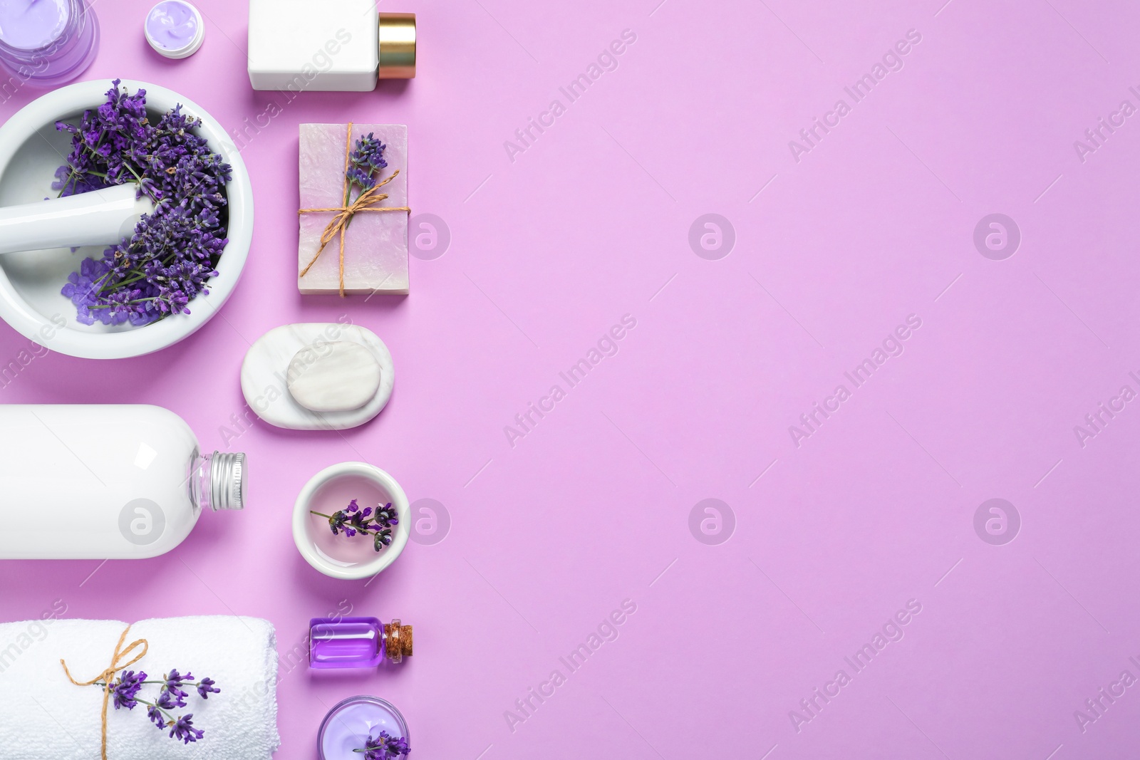 Photo of Cosmetic products and lavender flowers on lilac background, flat lay. Space for text