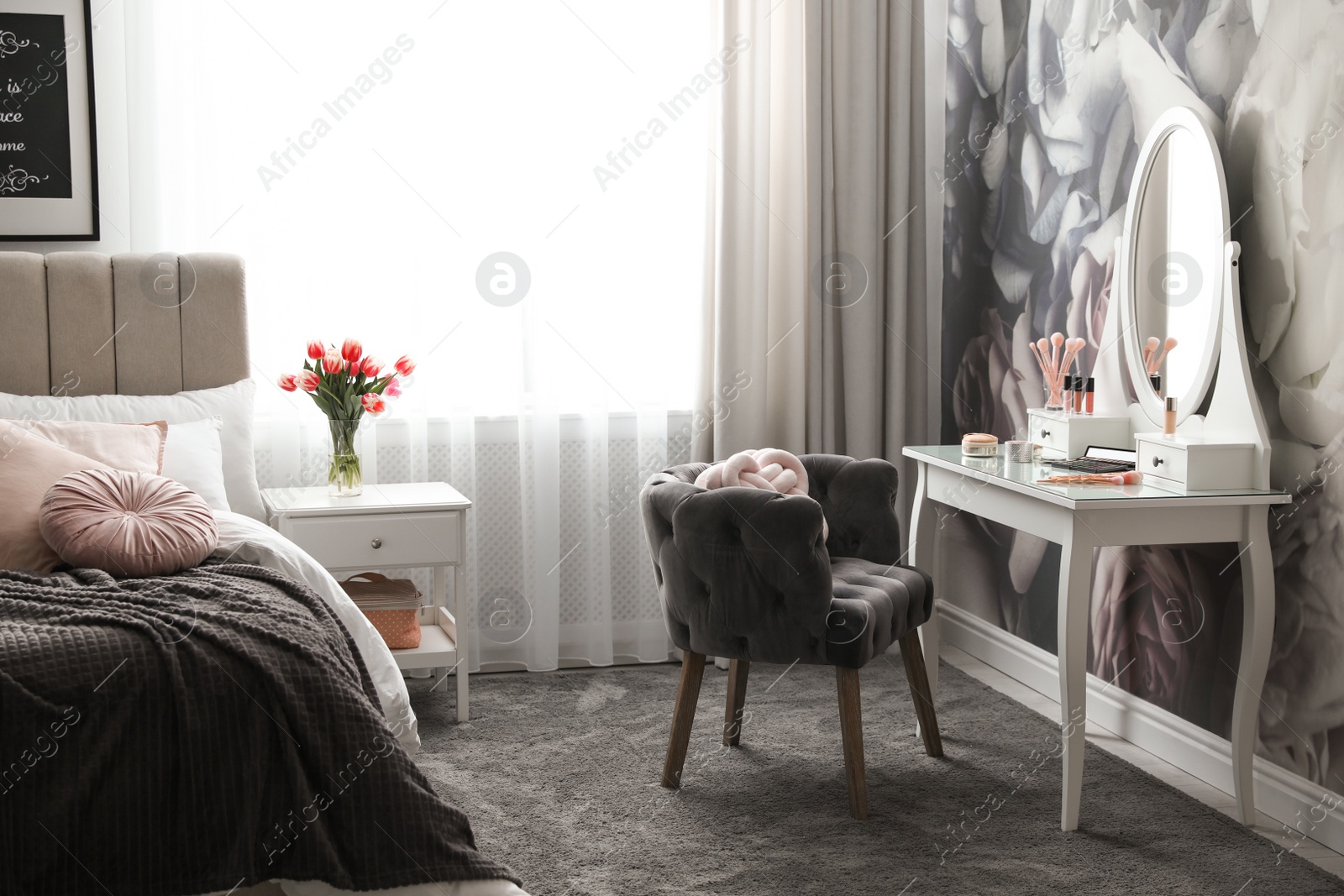 Photo of Stylish bedroom interior with elegant dressing table and floral wallpaper