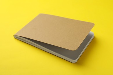 Photo of New stylish kraft planner on yellow background
