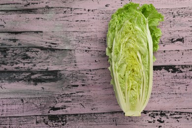 Cut fresh ripe Chinese cabbage on rustic table, top view. Space for text