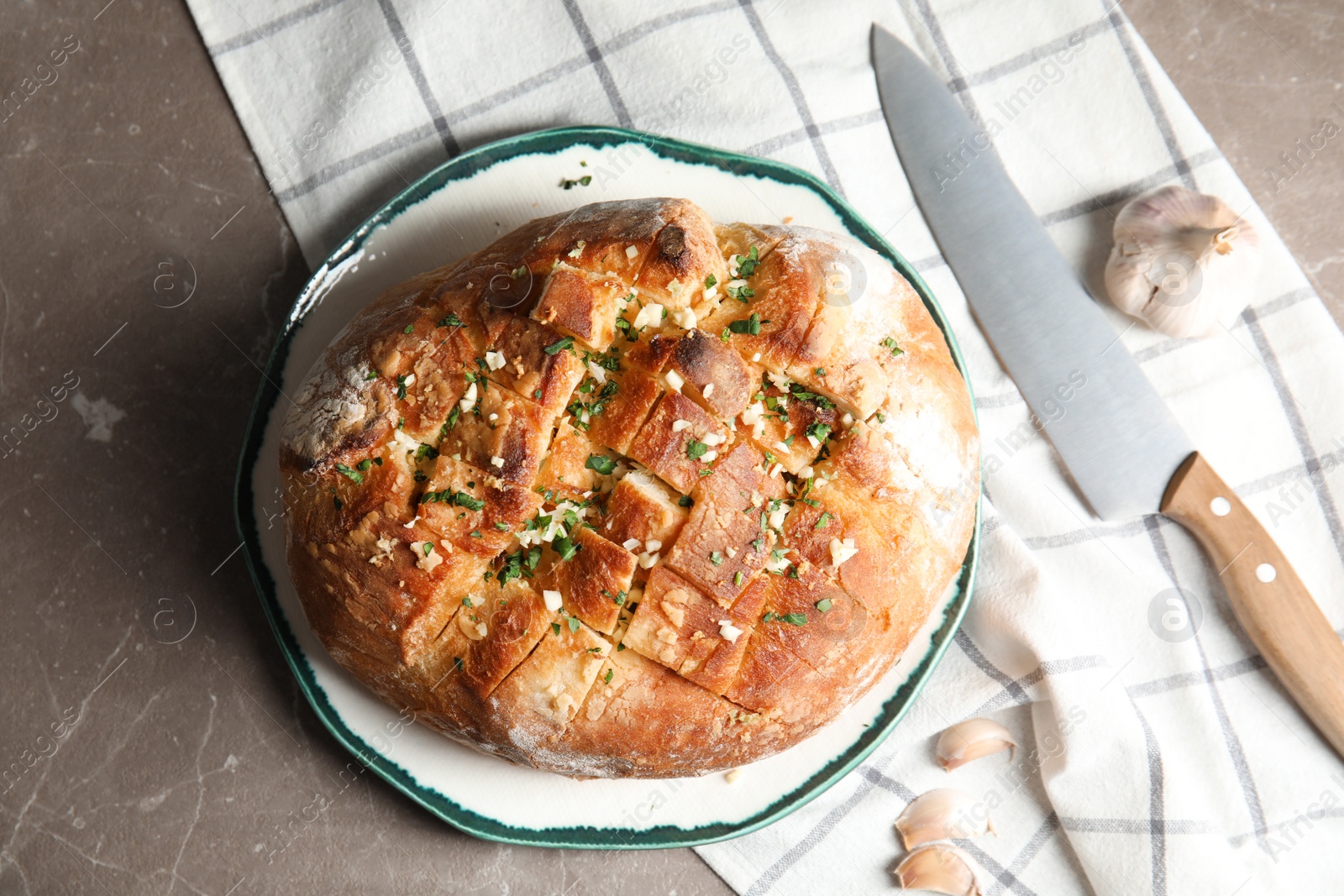 Photo of Flat lay composition with tasty homemade garlic bread on table