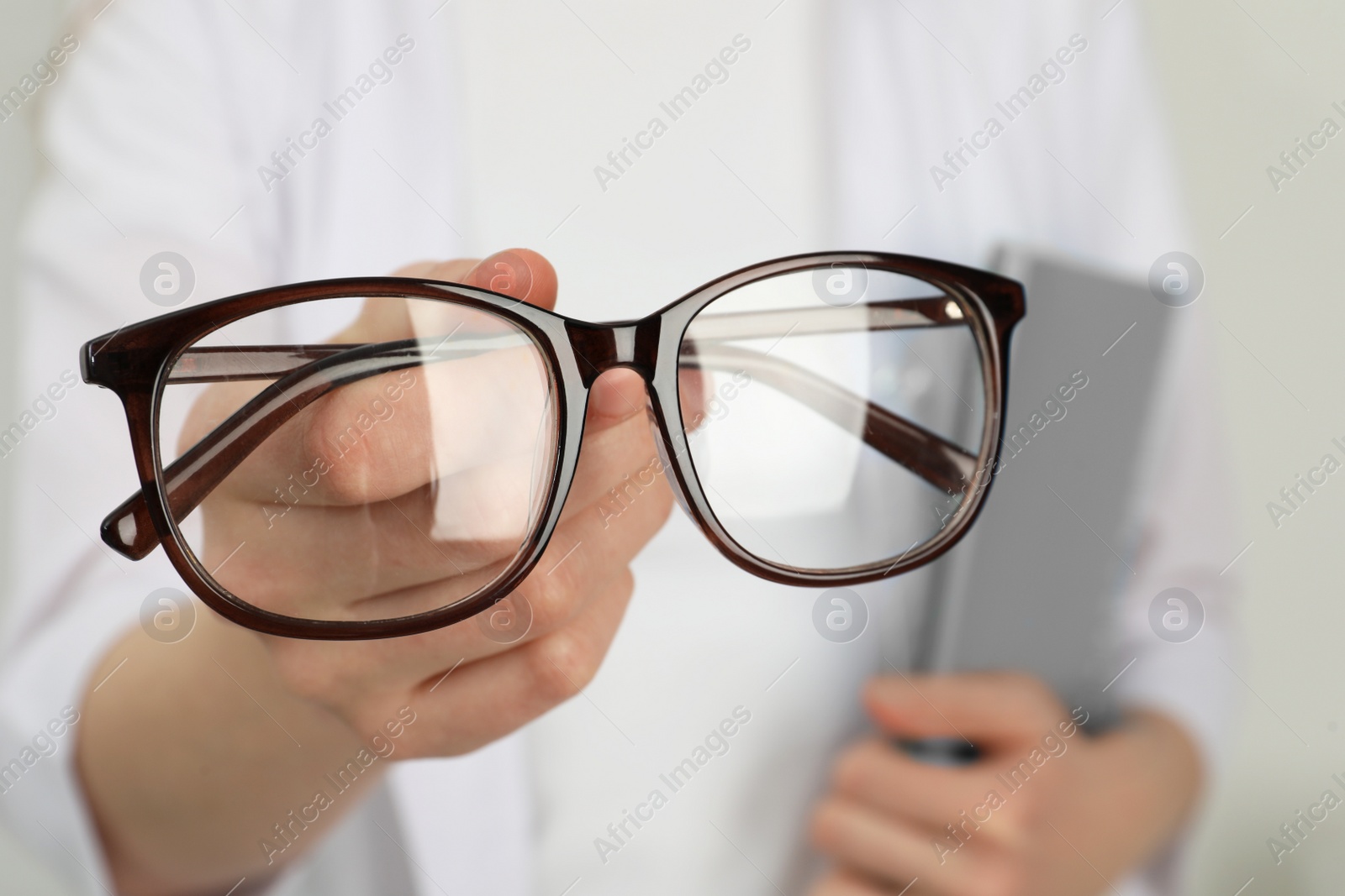 Photo of Woman with glasses on light background, closeup