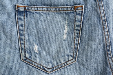 Light blue jeans with back pocket as background, closeup