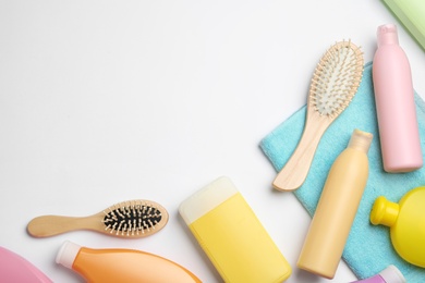 Photo of Flat lay composition with hair cosmetic products and tools on white background. Space for text