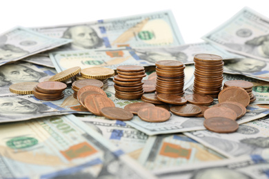 Dollar bills and coins on white background