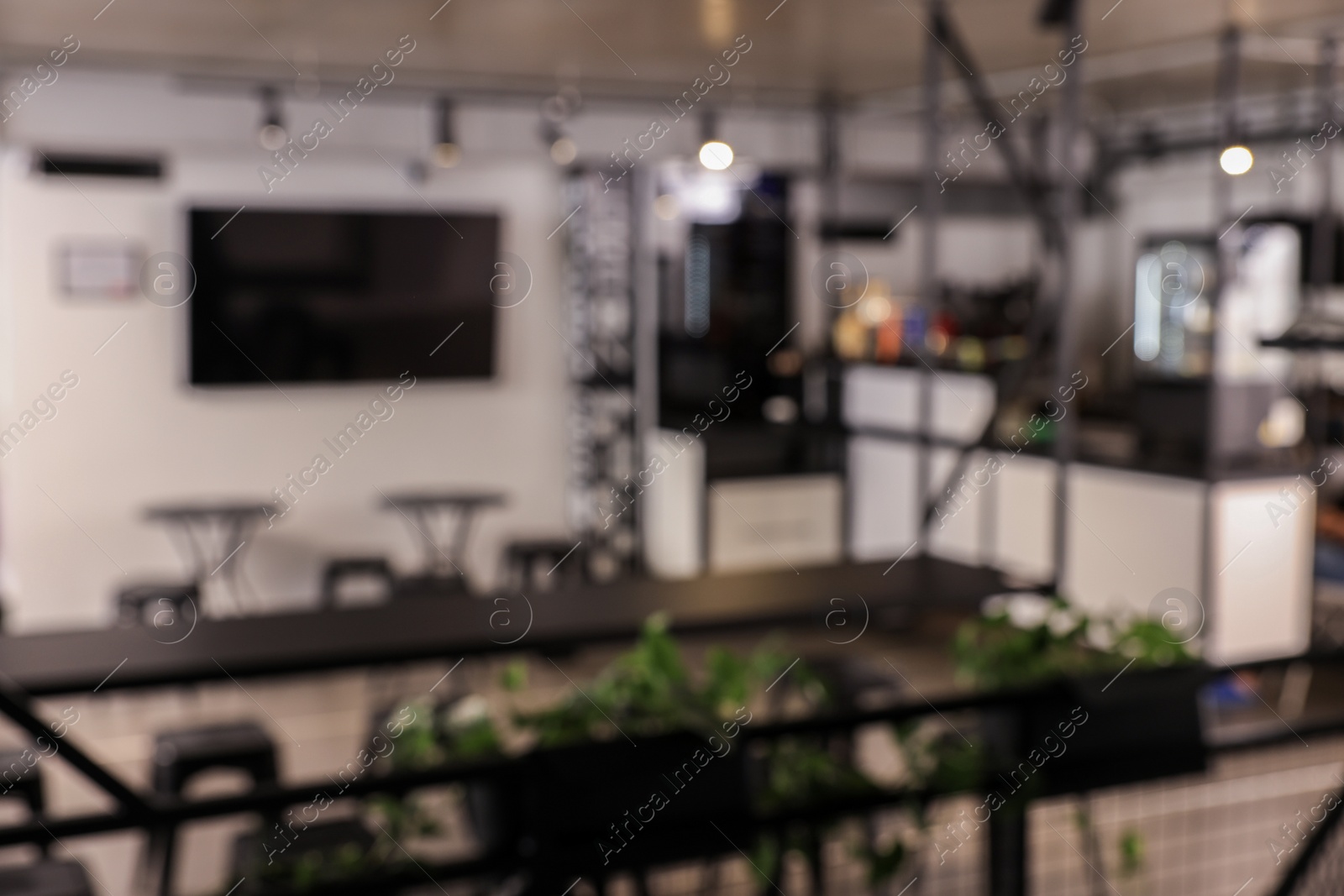 Photo of Blurred view of hostel dining room interior with comfortable furniture and coffee shop