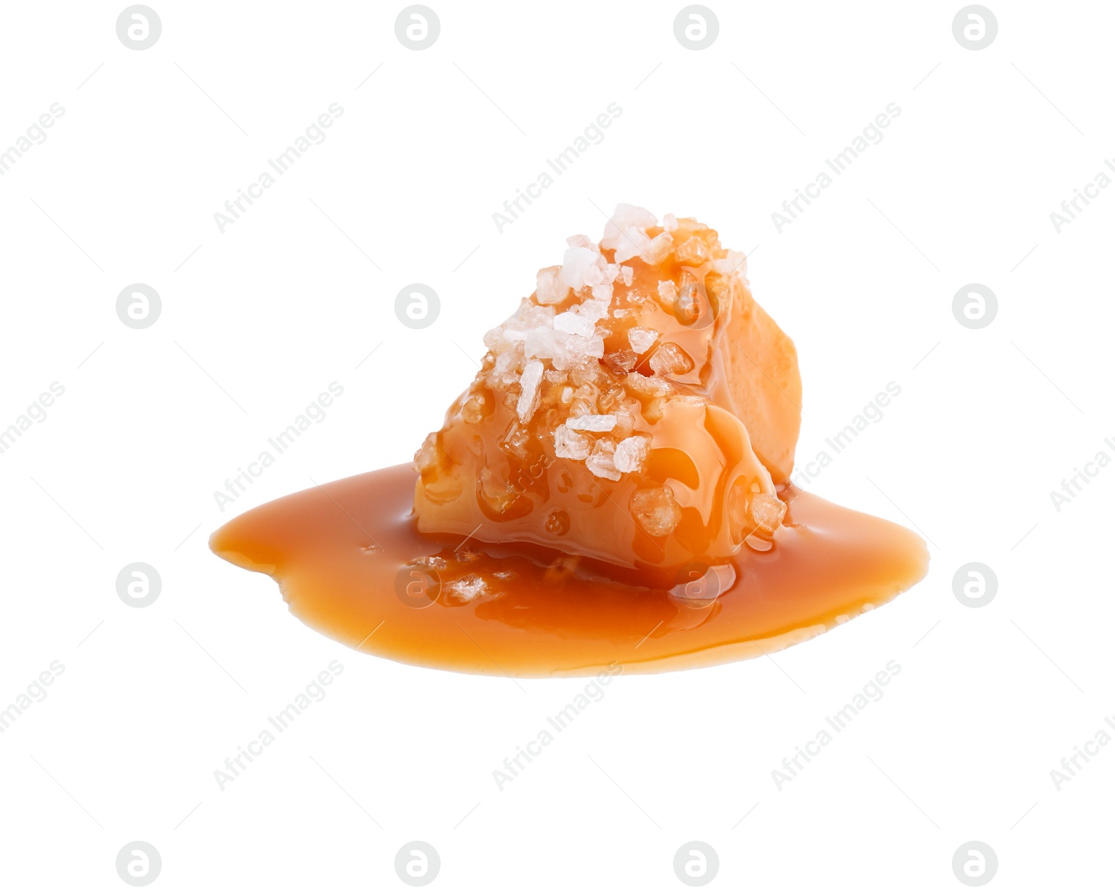 Photo of Yummy caramel candies and sea salt isolated on white