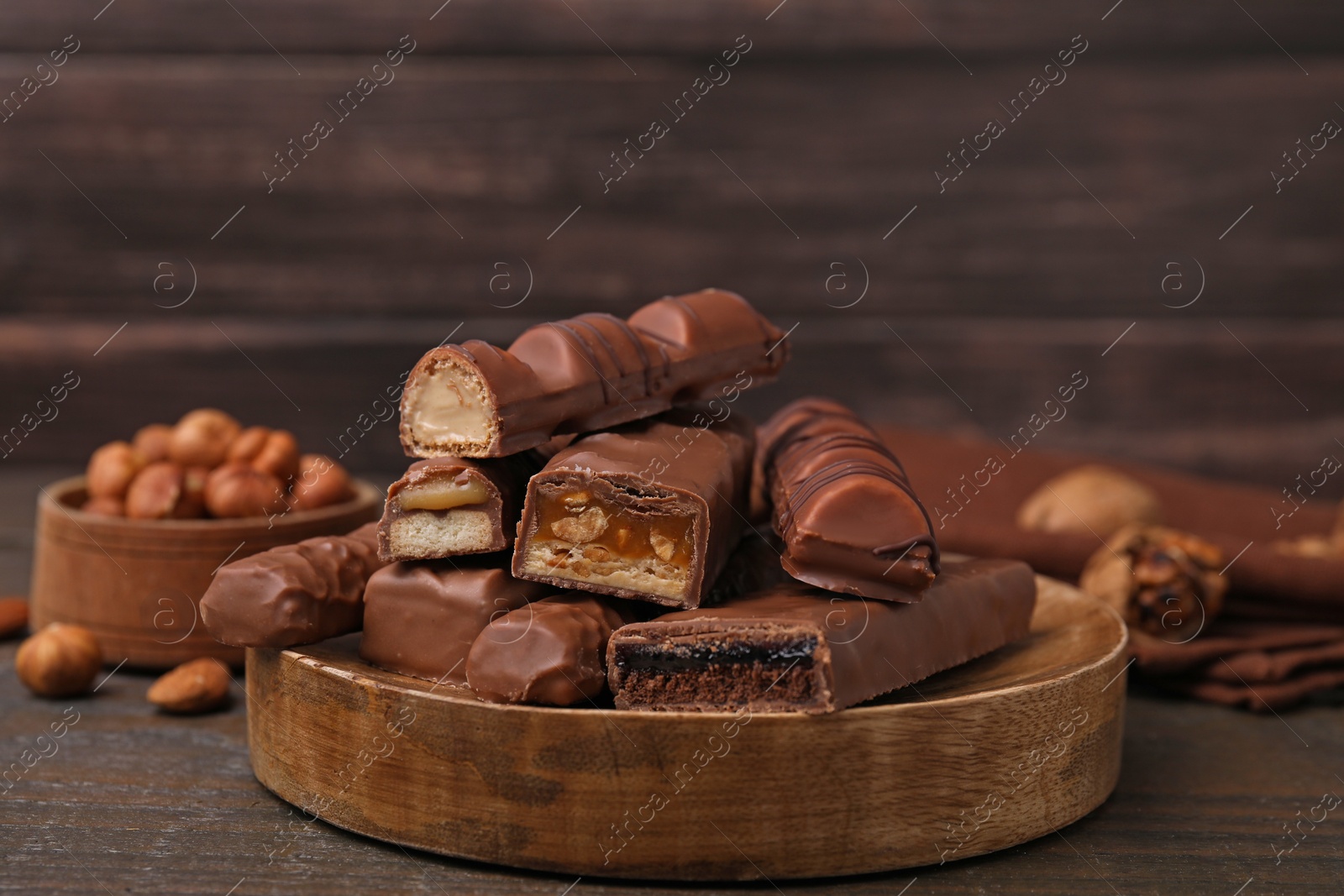 Photo of Pieces of different tasty chocolate bars on wooden table