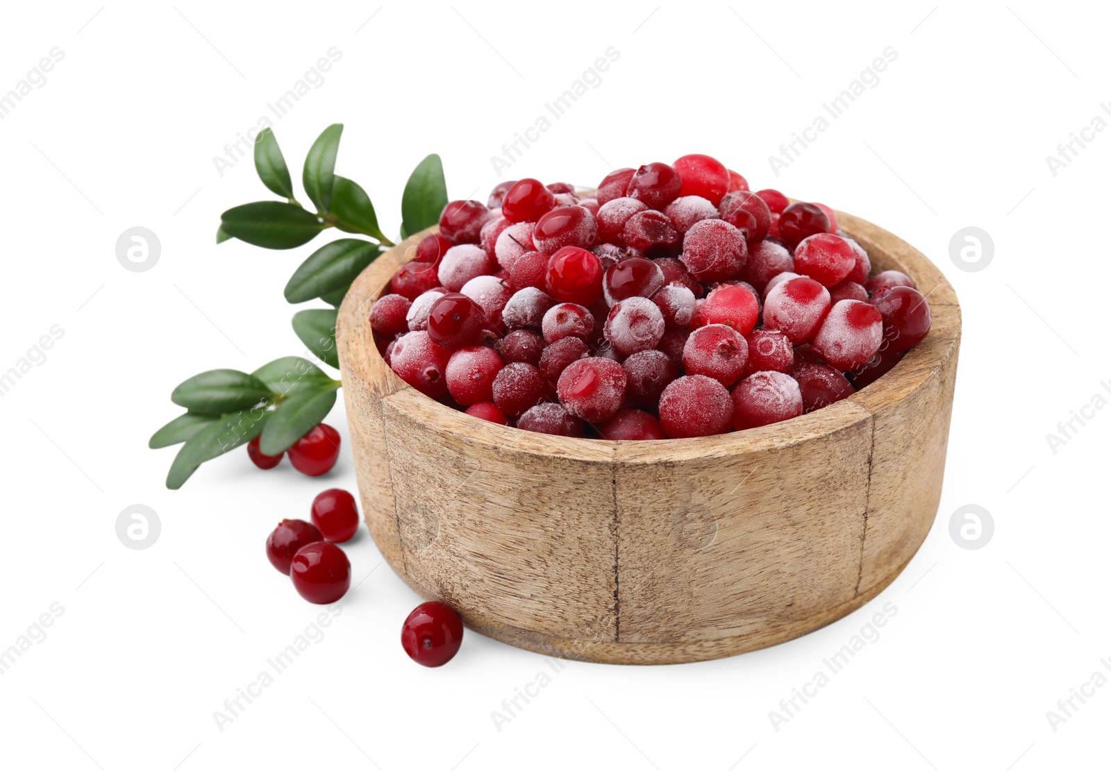 Photo of Frozen red cranberries in bowl and green leaves isolated on white