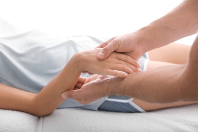 Photo of Young woman receiving massage in salon, closeup