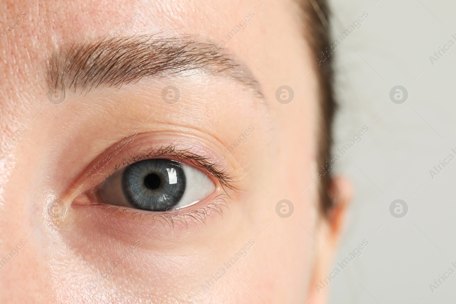 Photo of Closeup photo of woman with beautiful eyes on light background