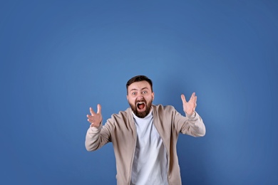 Portrait of handsome bearded man on color background