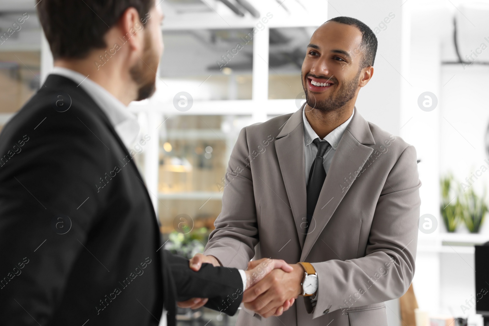 Photo of Lawyer shaking hands with client in office