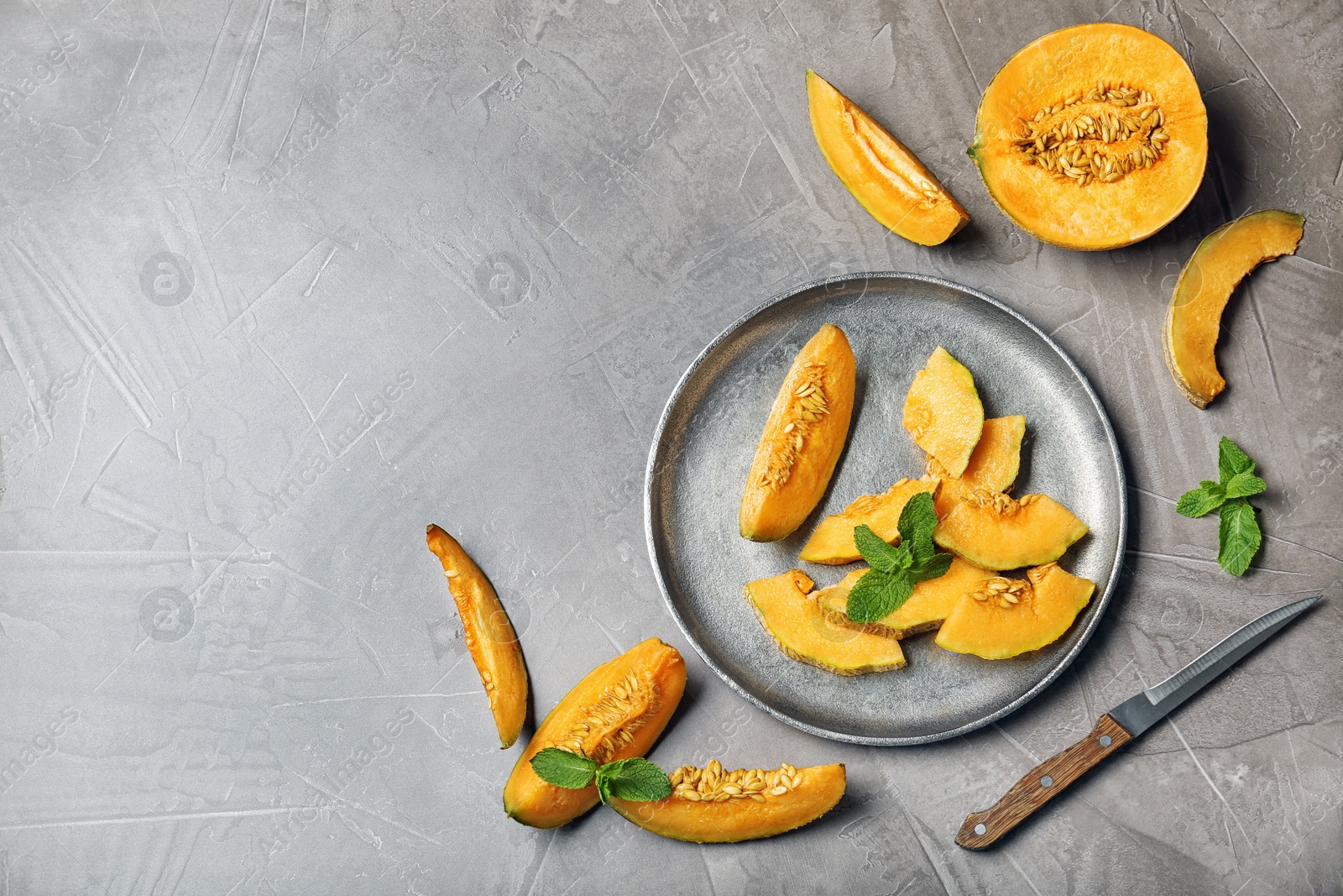 Photo of Slices of ripe melon on light table, flat lay. Space for text