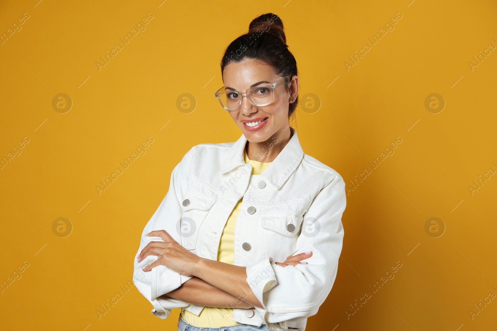 Photo of Beautiful woman in eyeglasses on yellow background