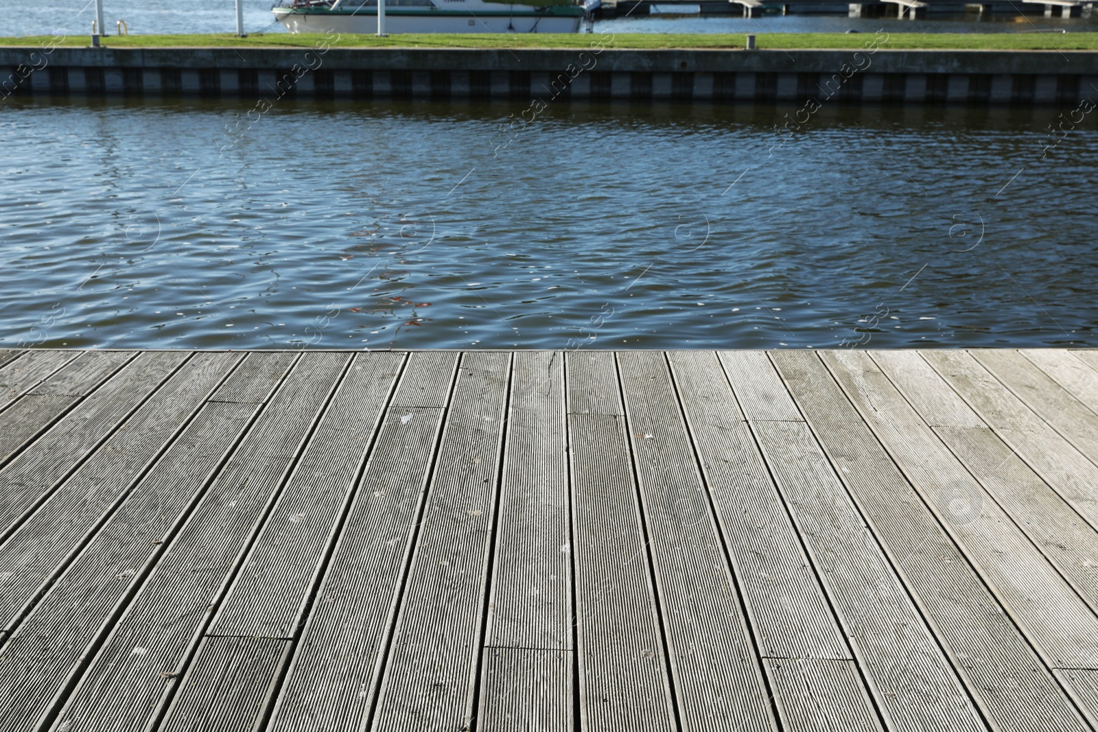 Photo of Beautiful view of wooden terrace near river on sunny day