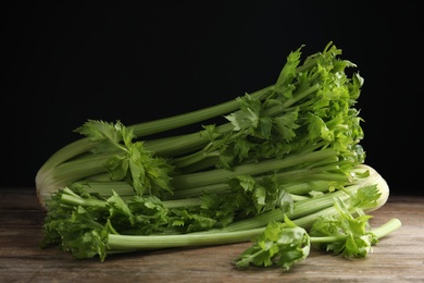 Photo of Fresh ripe green celery on wooden table