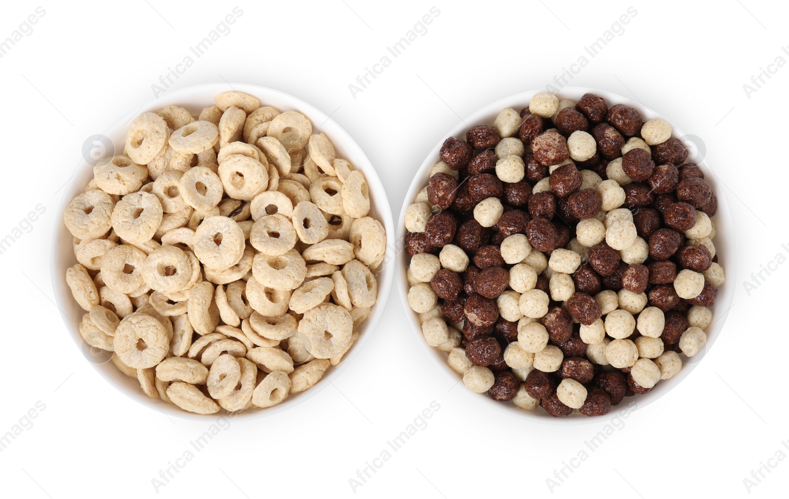 Photo of Different types of breakfast cereals in bowls isolated on white, top view