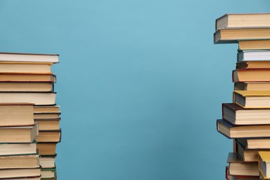 Photo of Many hardcover books on turquoise background, space for text. Library material