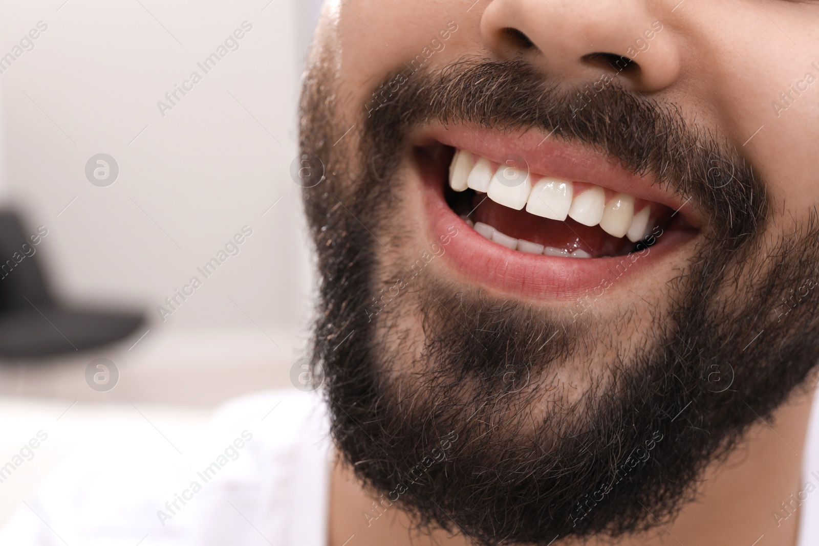 Photo of Happy young man with white teeth, closeup