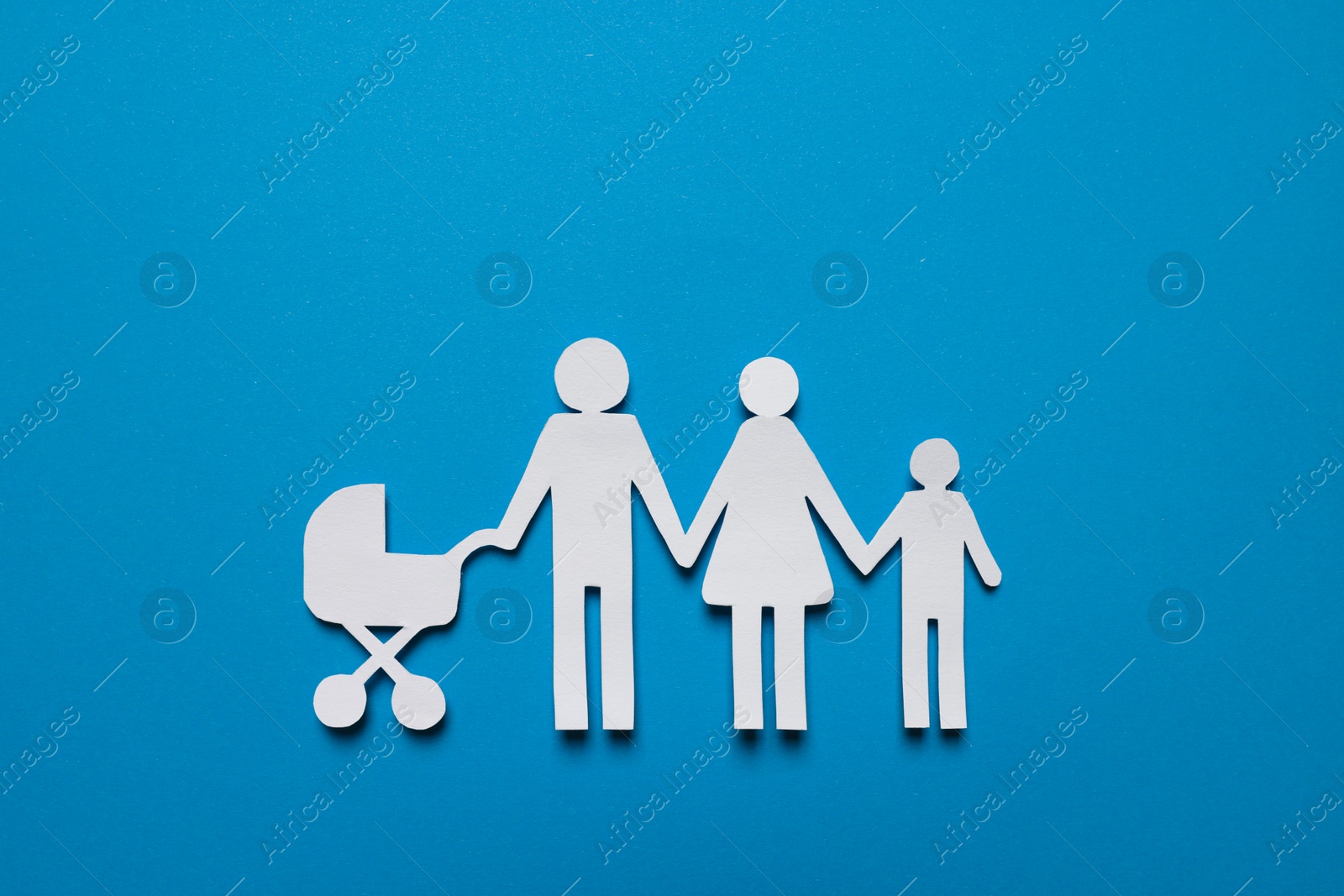 Photo of Paper family figures on light blue background, top view. Insurance concept