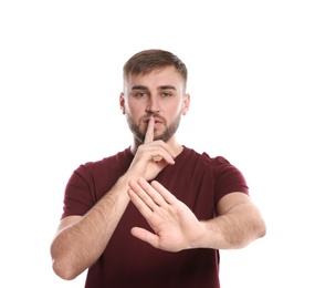 Photo of Man showing HUSH gesture in sign language on white background