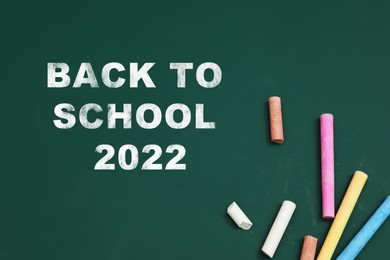 Image of Back to school 2022. Colorful chalks on greenboard, flat lay