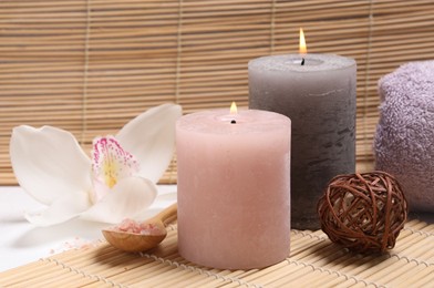 Photo of Composition with spa products, beautiful flower and burning candle on white table