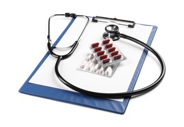 Photo of Clipboard, pills and stethoscope on white background