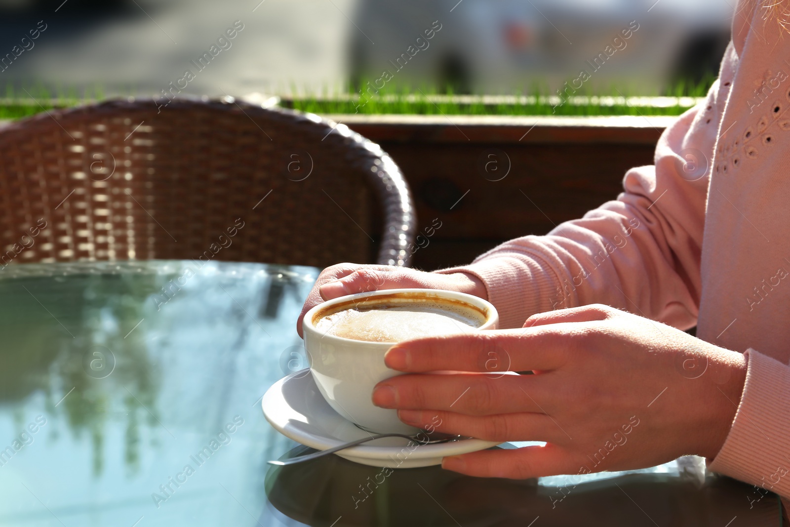 Photo of Woman with cup of fresh aromatic coffee at table in cafe