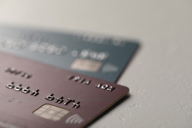 Photo of Two credit cards on gray background, closeup