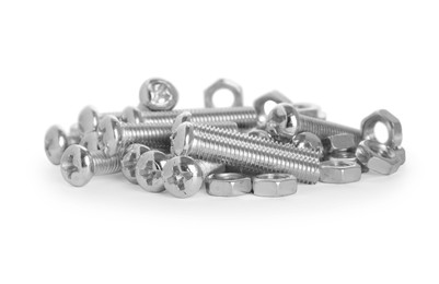 Photo of Many metal bolts and nuts on white background
