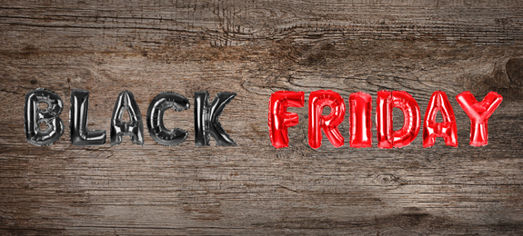 Image of Phrase BLACK FRIDAY made of foil balloon letters on wooden background. Banner design