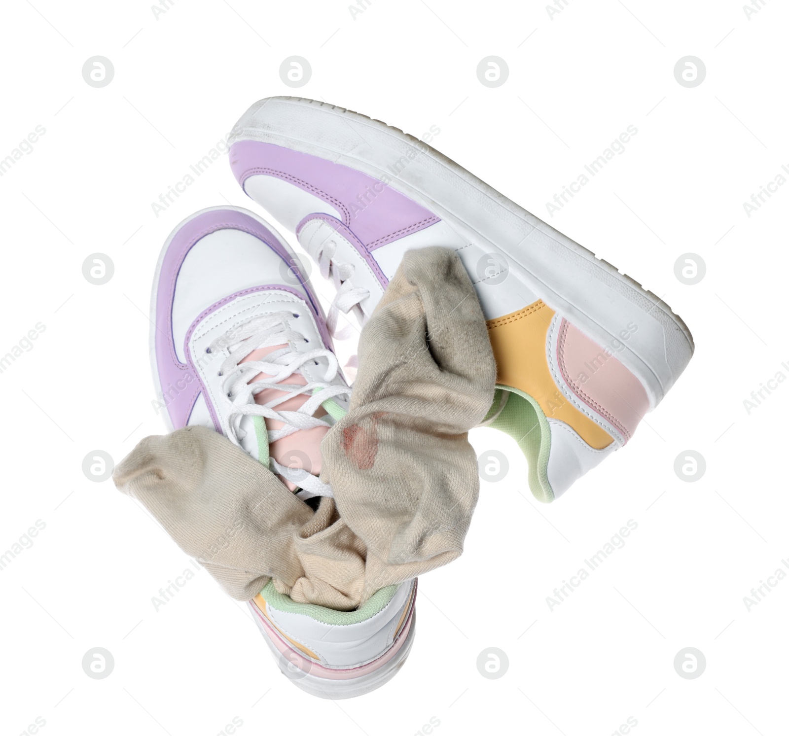 Photo of Dirty socks and sneakers on white background, top view