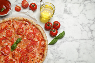Photo of Delicious pizza Margherita and ingredients on white marble table, flat lay