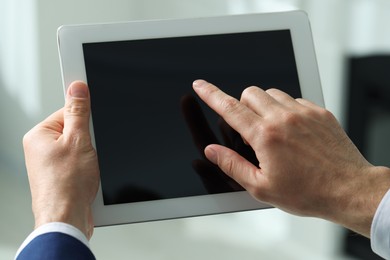 Photo of Closeup view of man using new tablet indoors