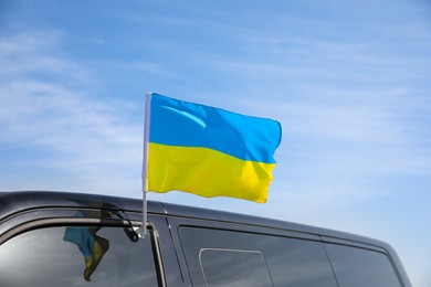 Photo of National flag of Ukraine on car window outdoors