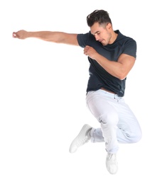 Photo of Young man in stylish jeans jumping on white background