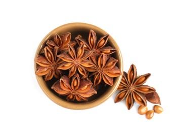 Photo of Bowl and dry anise stars on white background, top view