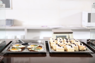 Photo of Trays with healthy food in school canteen