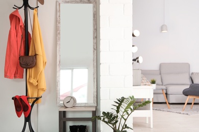 Photo of Stylish hallway interior with large mirror