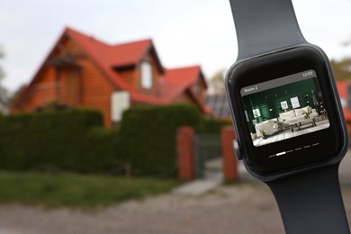 Image of Home security system. Modern smartwatch with image of room through CCTV camera on display against house, collage design