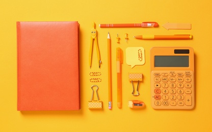 Flat lay composition with different school stationery on yellow background