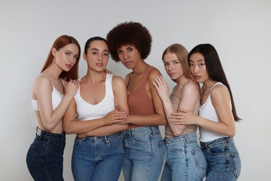 Photo of Portrait of beautiful young women on light grey background