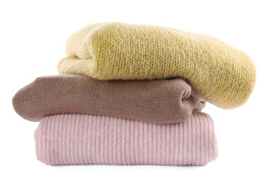 Photo of Stack of warm sweaters isolated on white