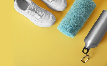 Photo of Flat lay composition with fitness equipment and space for text on color background