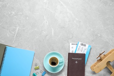 Photo of Flat lay composition with passport, notebook and tickets on grey marble table, space for text. Business trip