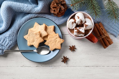 Photo of Flat lay composition of tasty cocoa with marshmallows on white wooden table