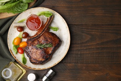 Photo of Tasty grilled meat, rosemary, tomatoes and marinade on wooden table, flat lay. Space for text