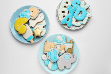 Photo of Set of baby shower cookies on light background, flat lay